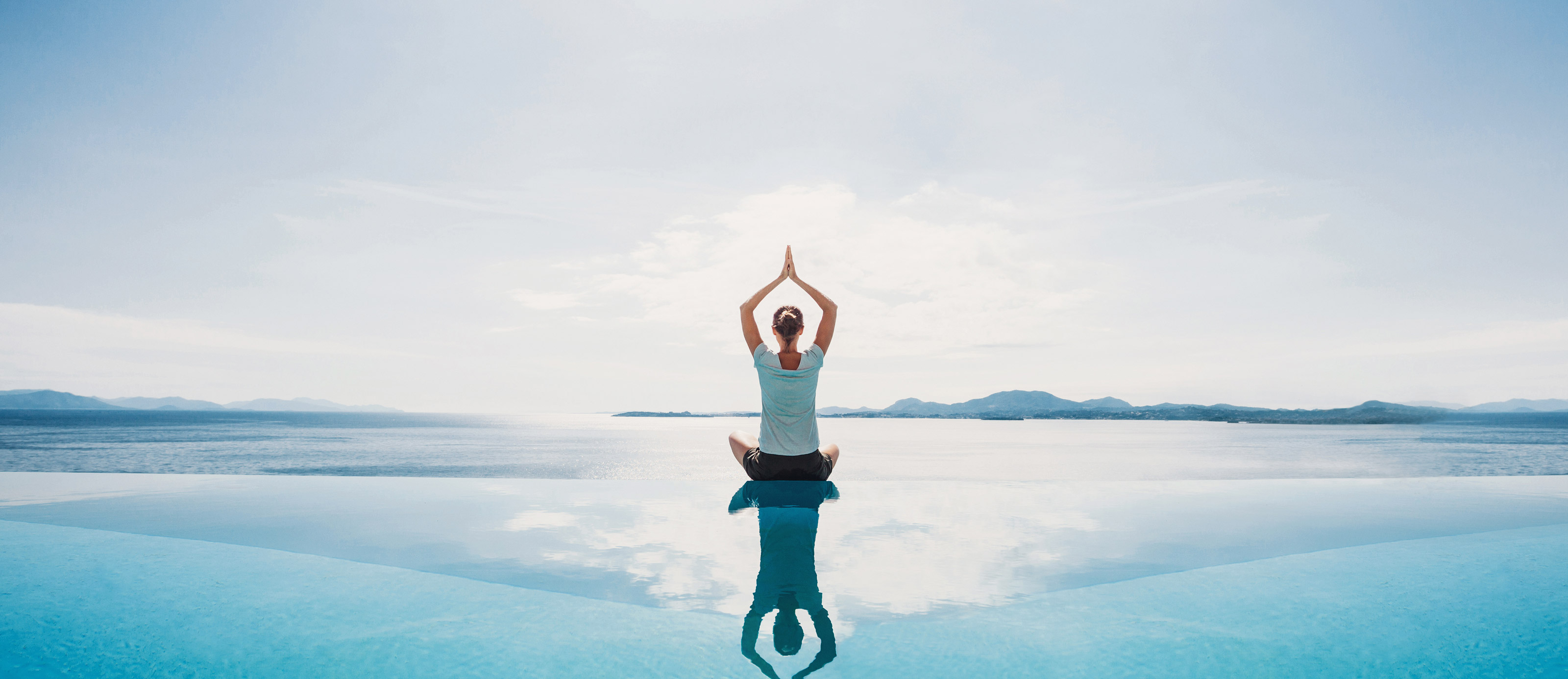 yoga on infinity pool